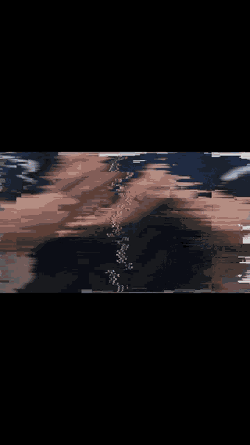 a blurry picture of a person 's face with a reflection of a person in the water