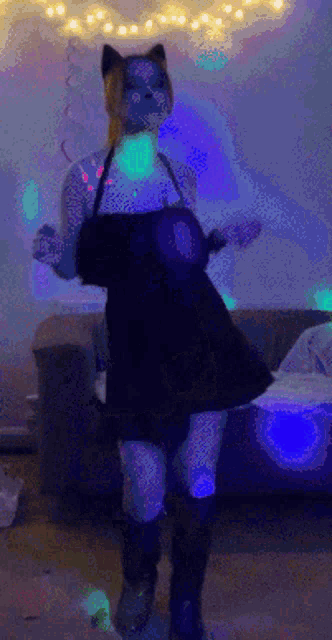 a woman in a cat mask is dancing in a room