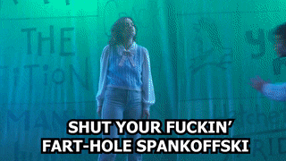 a man and a woman are standing in front of a green wall with the words shut your fuckin ' fart-hole spankoffski