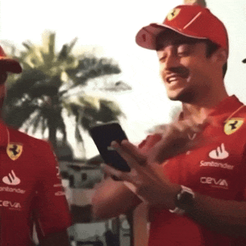 a man wearing a red shirt with santander on it