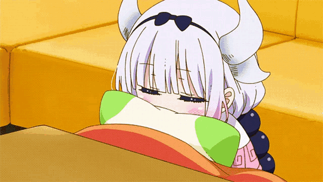 a girl with horns is laying on a table with her eyes closed
