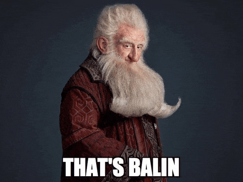 a man with a beard and mustache is standing in front of a dark background and says that 's balin .