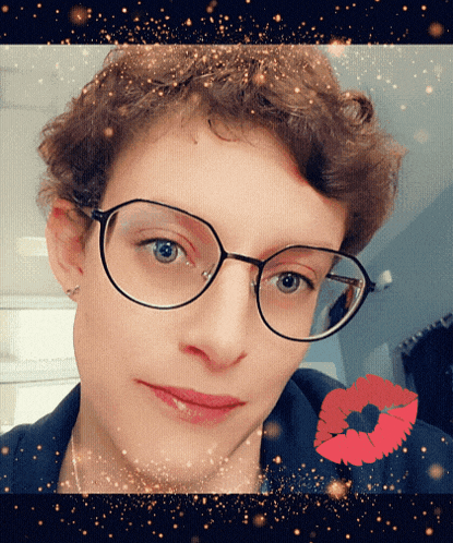 a woman wearing glasses has a red lip print in the background