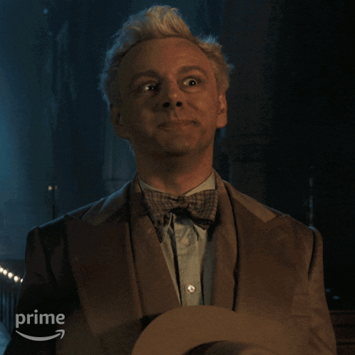 a man in a suit and bow tie is holding a hat and the word prime is on the bottom