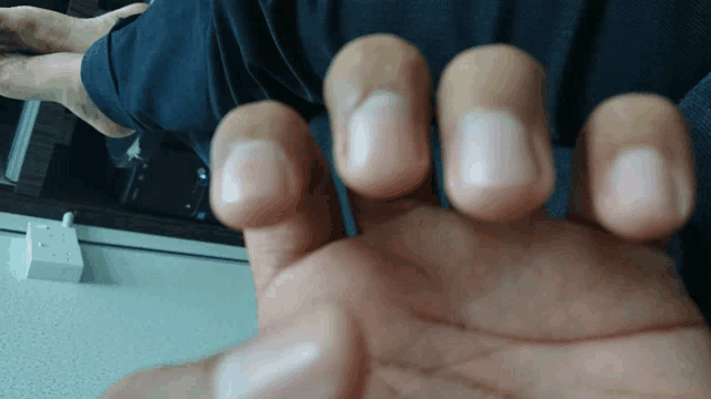 a close up of a person 's hand with their nails painted