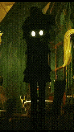 a silhouette of a witch with glowing eyes