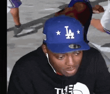 a man wearing a la hat and headphones