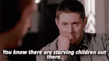 a man is sitting at a table with his hand on his chin and says `` you know there are starving children out there . ''