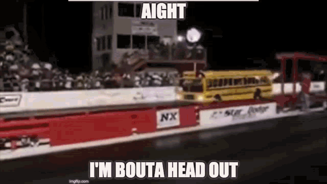 a school bus is driving down a drag strip at a race track .