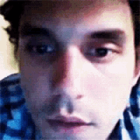 a close up of a man 's face with a purple background