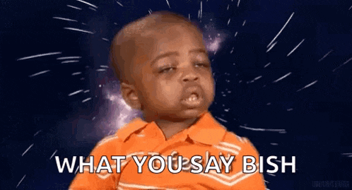a little boy in an orange shirt is making a funny face and saying `` what you say mish '' .
