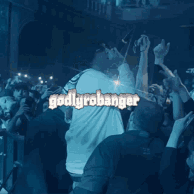 a man singing into a microphone in front of a crowd with godlyrobobanger written on the bottom
