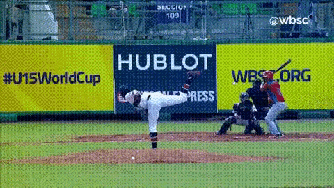 a baseball pitcher throws a pitch in front of a hublot sign