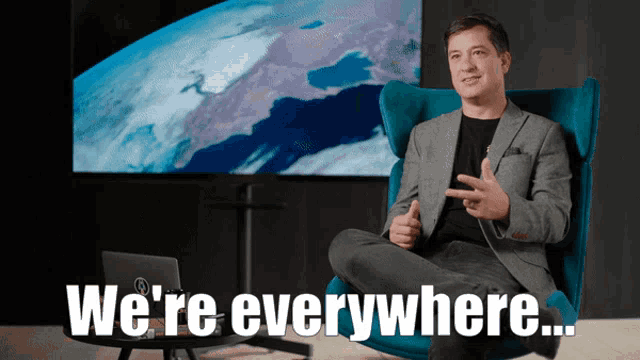 a man is sitting in a chair with the words we 're everywhere
