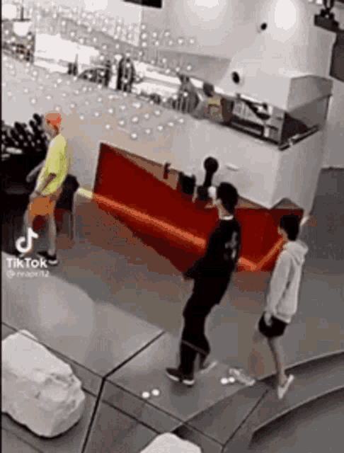 a group of people are standing around a table in a room .