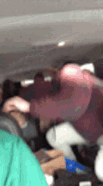 a blurry picture of a group of people sitting in a car