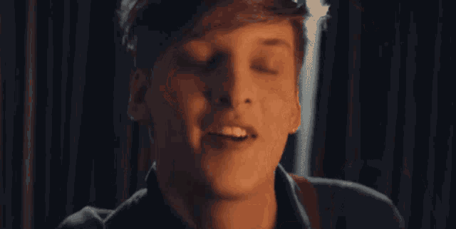 a close up of a man 's face with a smile on his face .