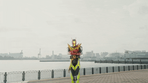a man in a superhero costume is standing in front of a fireball