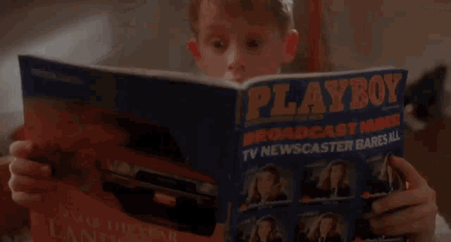a young boy in a white sweater is looking into a drawer