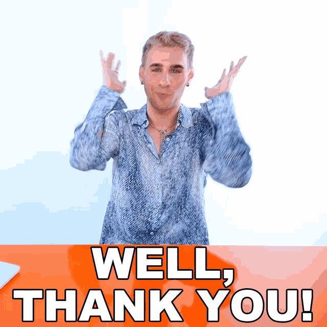 a man in a blue shirt is standing in front of an orange sign that says " well thank you "