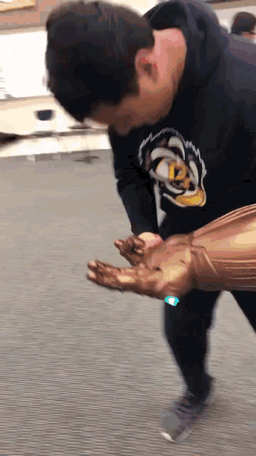 a man in a black sweatshirt with a tiger on it