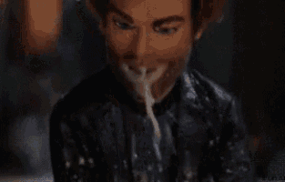 a close up of a man with a beard drinking water .
