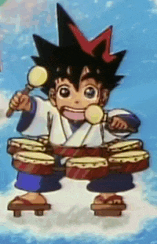 a boy in a kimono is playing drums and holding a microphone