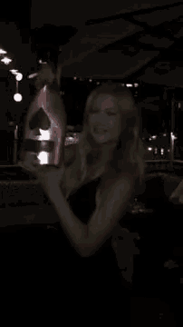 a woman holds a bottle of ace of spades champagne in her hand