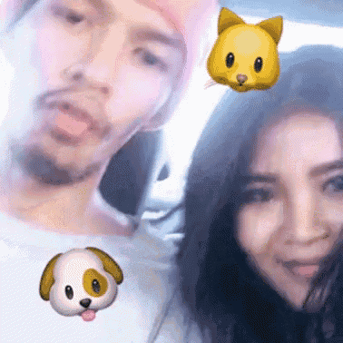 a man and a woman are posing for a picture with a dog and a cat emoji on their faces