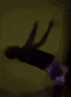 a person 's shadow is cast on a wall