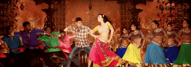 a man and woman are dancing in front of a crowd