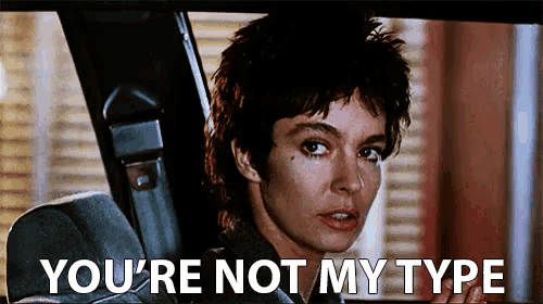 a woman sitting in a car with the words " you 're not my type " below her