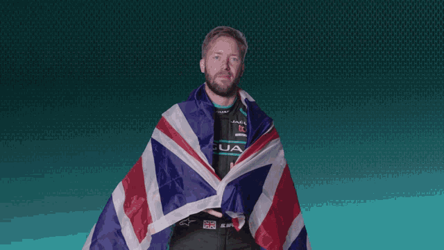 a man wrapped in a british flag holds up his finger