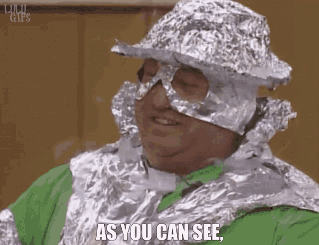 a man is wrapped in tin foil with the words as you can see below him