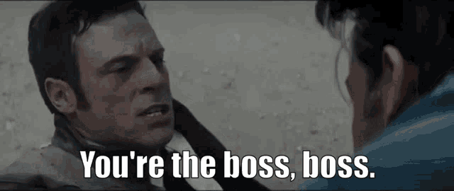 two men are standing next to each other and one of them is saying " you 're the boss boss "
