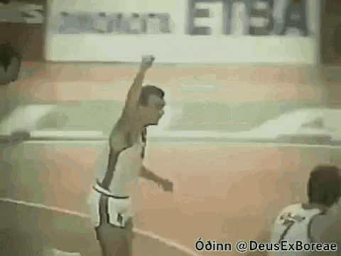 a man is jumping in the air on a basketball court with his arms in the air .