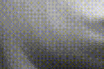 a black and white photo of a person 's face with a gray background