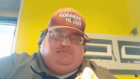 a man wearing a hat that says robbier2 vlog