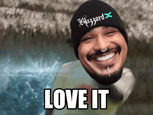 a man wearing a blizzard hat is smiling with the words love it below him