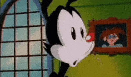 a cartoon character is standing in front of a window with a picture of a woman in the background .
