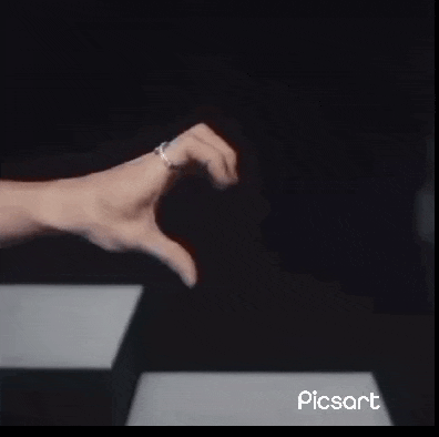 a close up of a person 's fist against a table .