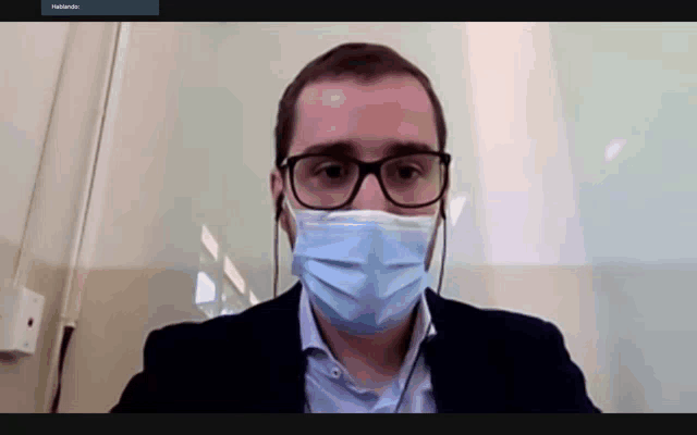 a man wearing glasses and a face mask is on a video call with a name that starts with h