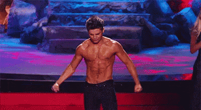a shirtless man is standing on a stage .