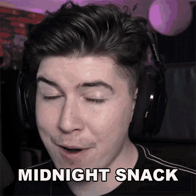 a man wearing headphones says " midnight snack " in front of his face