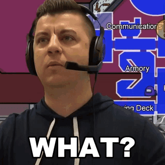 a man wearing headphones and a microphone is asking the question " what "