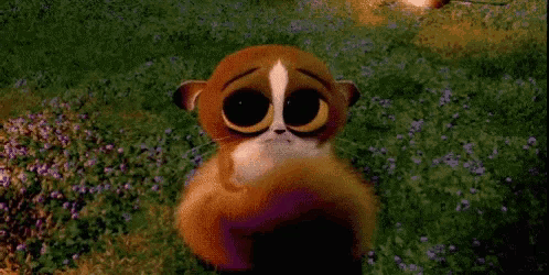 a cartoon animal with big eyes is standing in a field of purple flowers .