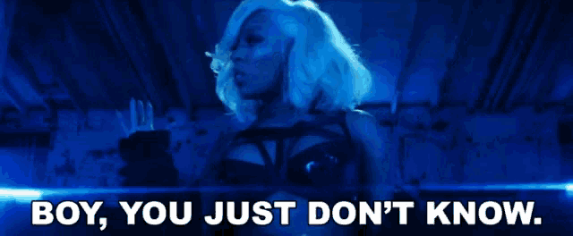a woman in a black bra with the words boy you just don 't know behind her