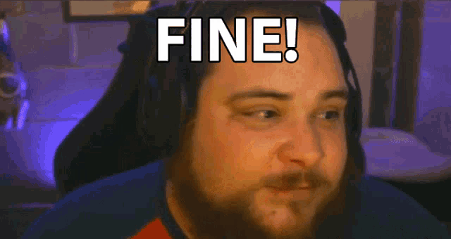 a man with a beard is wearing headphones and saying fine
