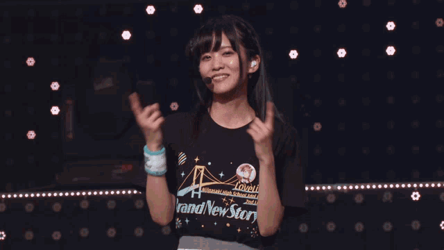 a girl wearing a black shirt that says " and new star " on it