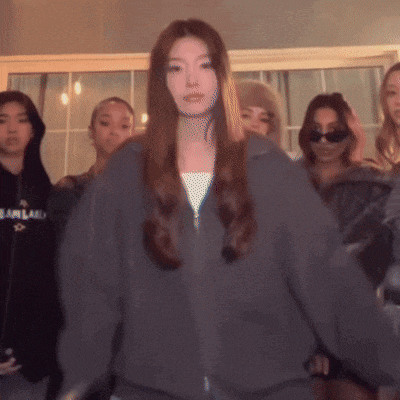 a woman wearing a grey sweatshirt with the word fearland on it